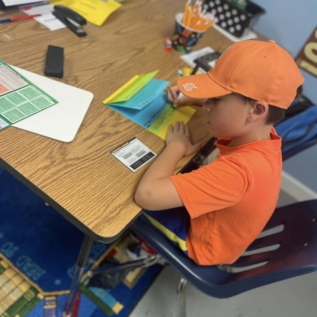 A student writing at a desk